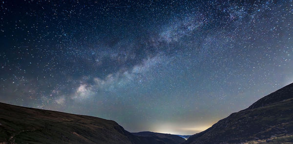 Low angle view of mountain against sky at night