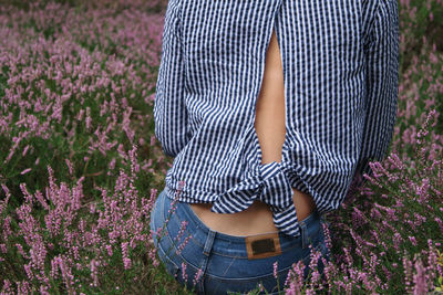 Low angle view of woman standing on field