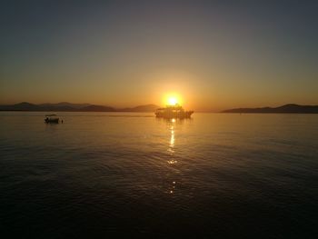 Scenic view of sea against clear sky during sunset