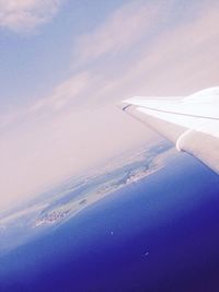 Cropped image of airplane flying over sea
