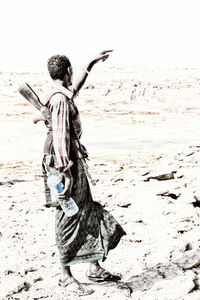 Rear view of woman standing on beach