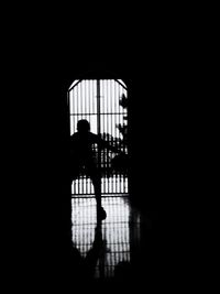 Silhouette man walking in corridor