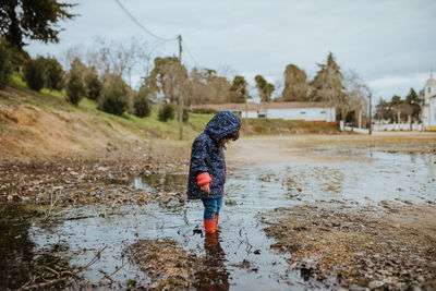 Full length of girl standing in water outdoors