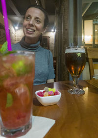 Portrait of a smiling man with drink in restaurant