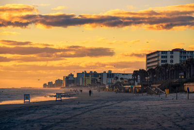 Scenic view of beach against sky during sunset