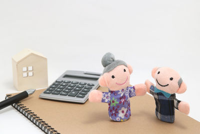 Close-up of toys on table against white background