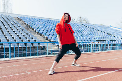 Portrait of woman standing on running track 