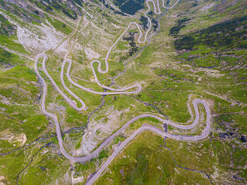 High angle view of winding road amidst trees