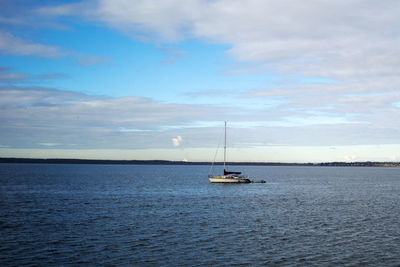 Sailboat sailing on sea against sky