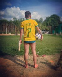 Rear view of man standing on field