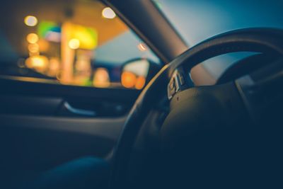 Close-up of car steering wheel at night