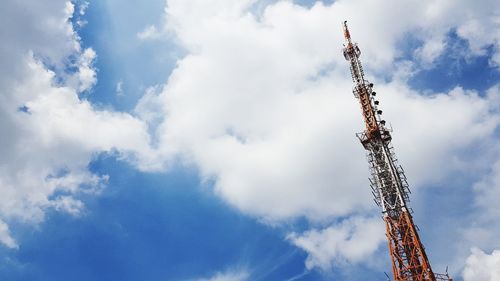 Low angle view of cranes against sky