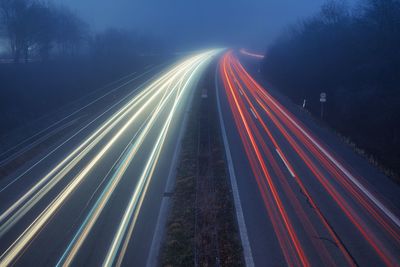 High angle view of light trails on highway at night