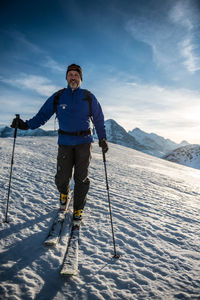 Full length of person on snowcapped mountain against sky