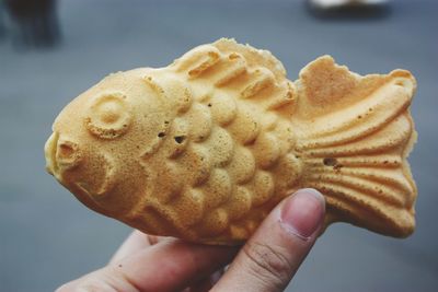 Close-up of hand holding ice cream