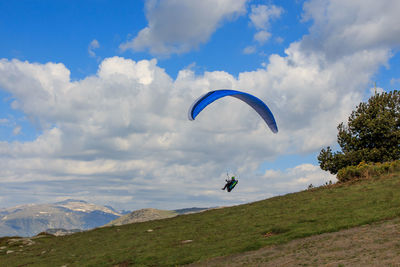 Paragliding flying through the green meadows.sport concept