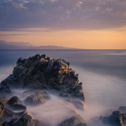 Scenic view of sea against sky during sunset