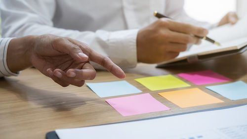 Midsection of businessman planning in office