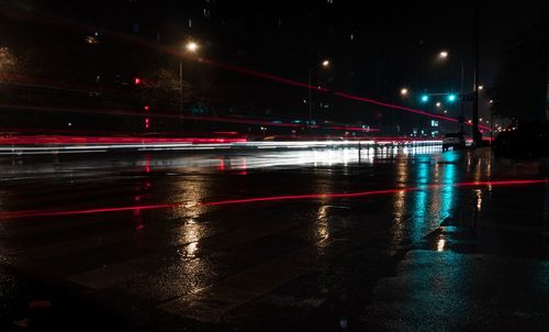 Light trails on wet road during rainy season at night