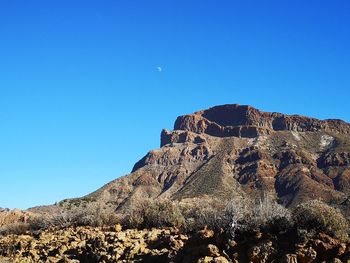 Low angle view of rock formation against sky