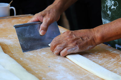 Midsection of man preparing food on table