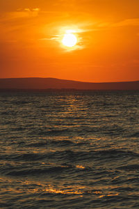 Scenic view of sea against romantic sky at sunset