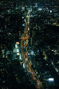 High angle view of illuminated buildings in city at night