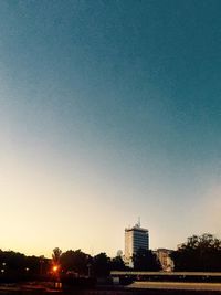 View of trees against clear sky at sunset