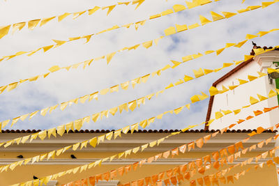 Low angle view of flags against sky