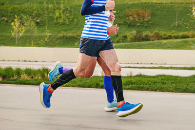 Rear view of woman exercising on field