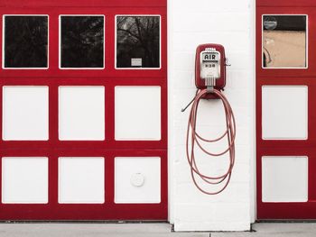 Vintage air pump on wall at fuel pump