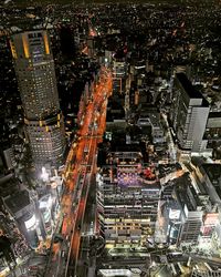 High angle view of illuminated modern buildings in city at night