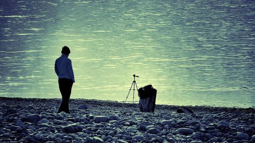 Rear view of man standing on rocks