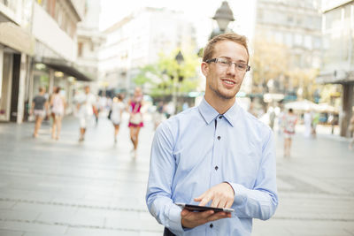 Portrait of young man standing on street