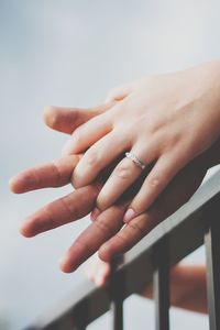 Cropped image of couple holding hands