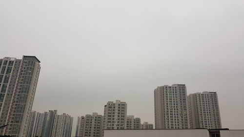 Modern buildings in city against clear sky