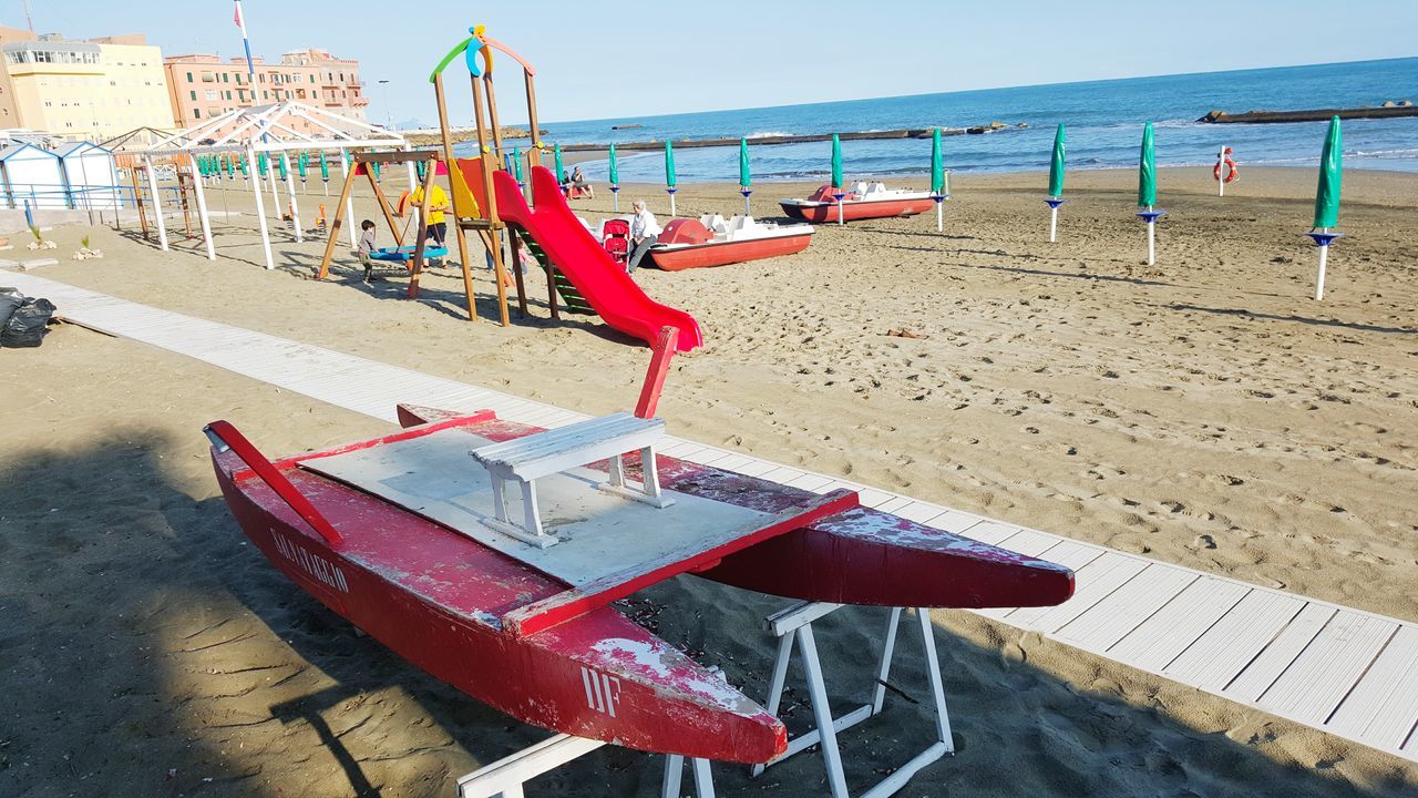 beach, water, sea, sand, moored, shore, nautical vessel, transportation, boat, horizon over water, day, absence, mode of transport, outdoors, sunlight, chair, deck chair, lounge chair, tranquility, incidental people