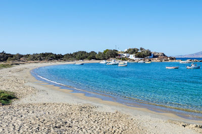 Scenic view of beach against clear blue sky