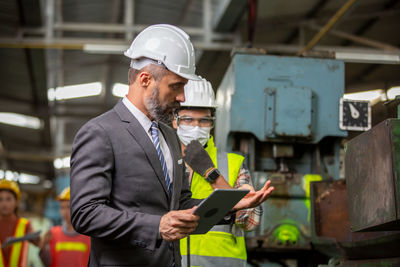 Side view of man working at construction site