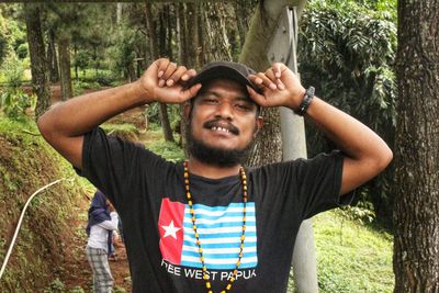 Portrait of man standing in forest