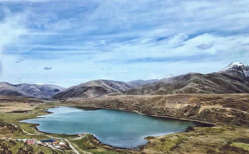 Scenic view of lake against cloudy sky