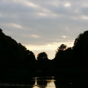 Scenic view of lake against cloudy sky