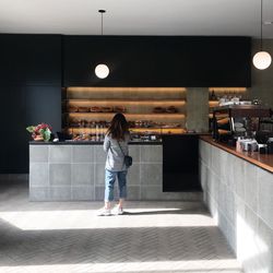 Rear view of woman standing in cafe