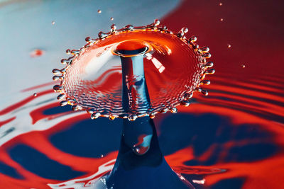 Close-up of water drops on red umbrella