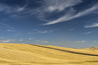 Scenic view of arid landscape against sky