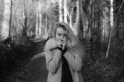 Portrait of young woman in forest