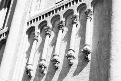 Low angle view of carvings on wall against sky