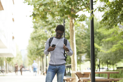 Young man using mobile phone outdoors