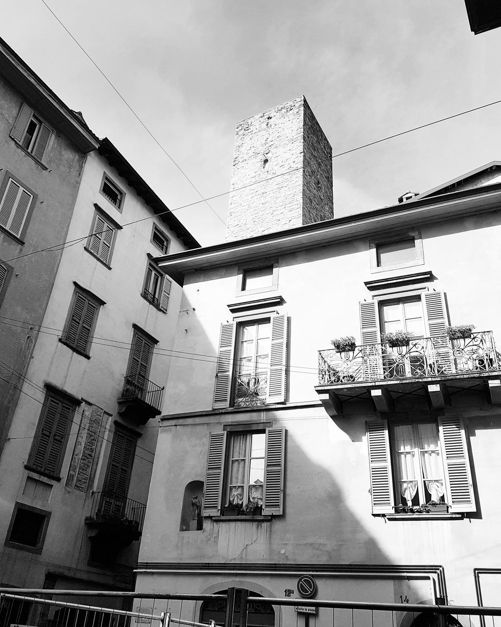 built structure, architecture, building exterior, low angle view, building, window, sky, no people, cloud - sky, day, residential district, city, nature, outdoors, balcony, glass - material, hanging, sunlight, apartment, cable