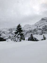 Scenic view of snow covered mountains against sky